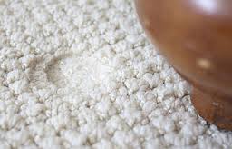 Carpet with visible furniture dents being restored by a professional Boston carpet cleaner