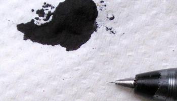 Close-up of an ink stain on a fabric sofa before professional cleaning
