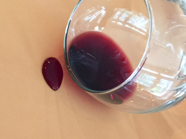 Red wine beading on fabric protected with professional fabric protection treatment