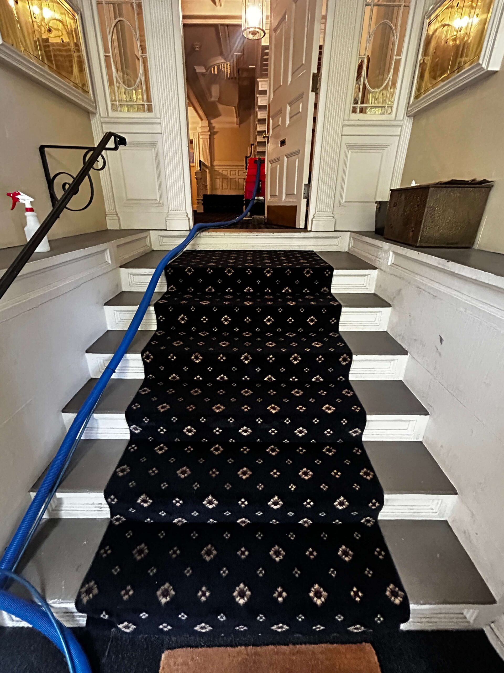 Freshly cleaned black carpeted staircase in a Lynnfield, MA home after professional carpet cleaning.