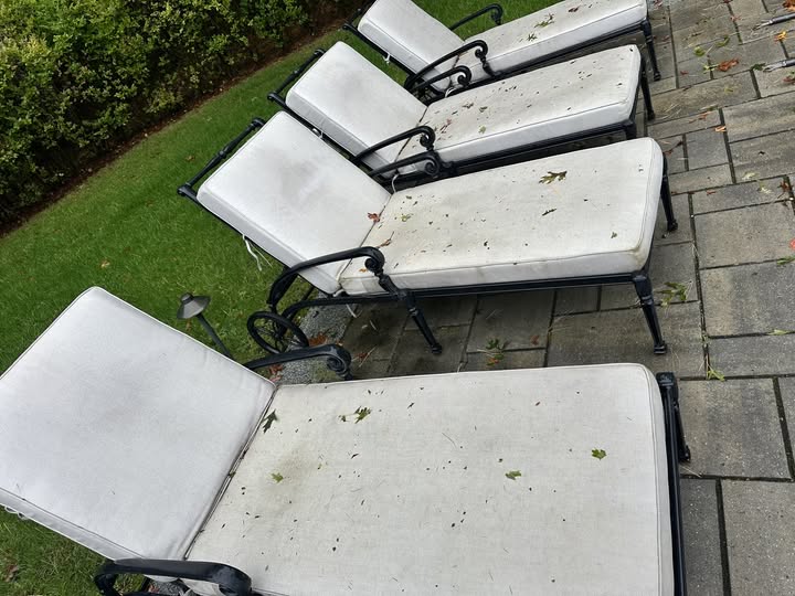 Dirty outdoor furniture cushions before professional cleaning at a customer's home