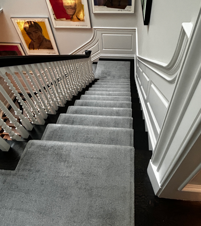 Professional carpet cleaning on a gray staircase in a luxury Massachusetts home.