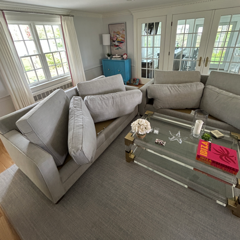 Freshly cleaned sectional sofa and upholstered chairs in a Needham, MA living room after professional upholstery cleaning.