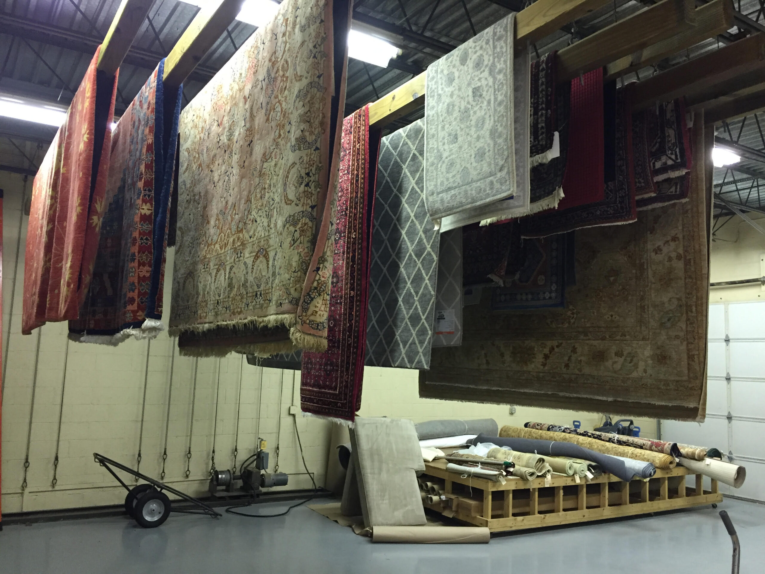 Area rugs hanging to dry after professional cleaning